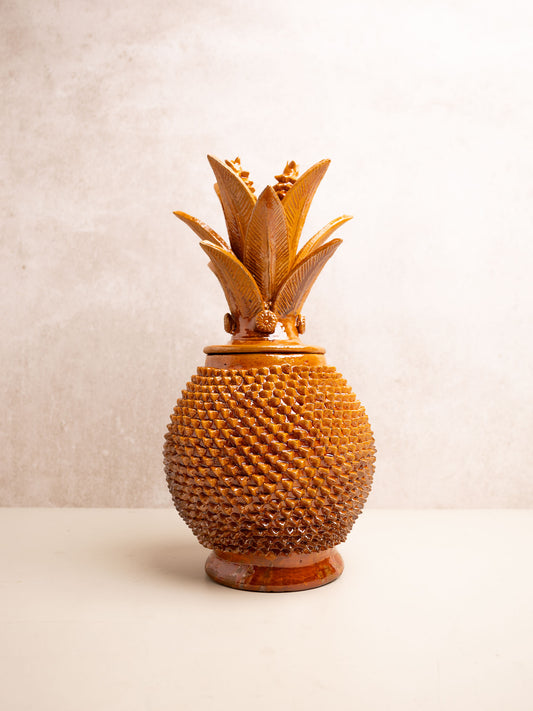 Yellow enameled pineapple "pinch" design with green leaves